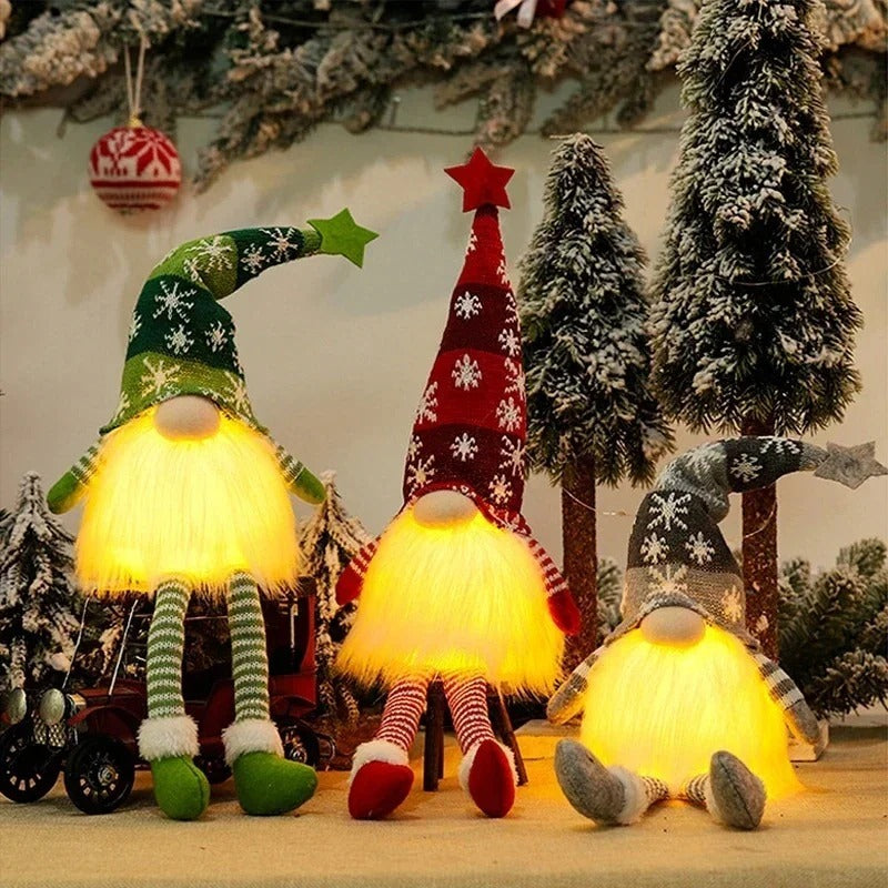 Glowing gnome trio on a table with snowy mini trees