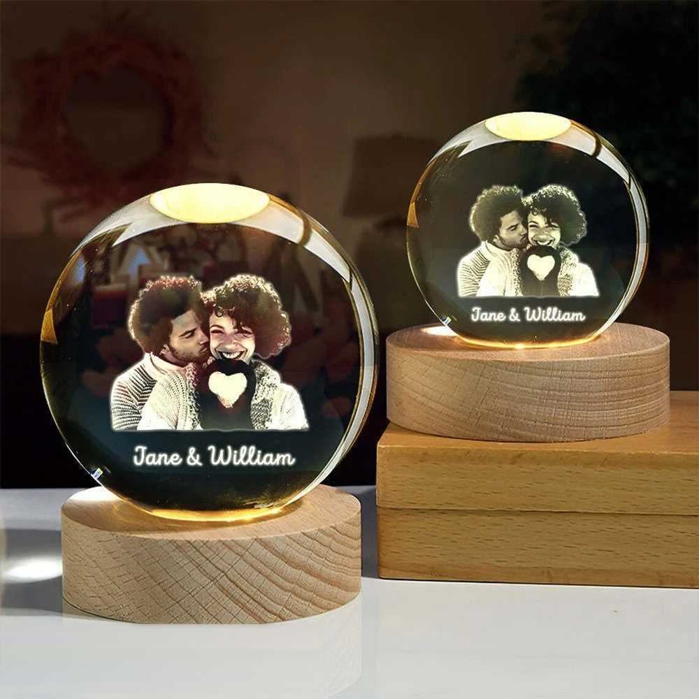 Two engraved photo crystal globes on wooden bases