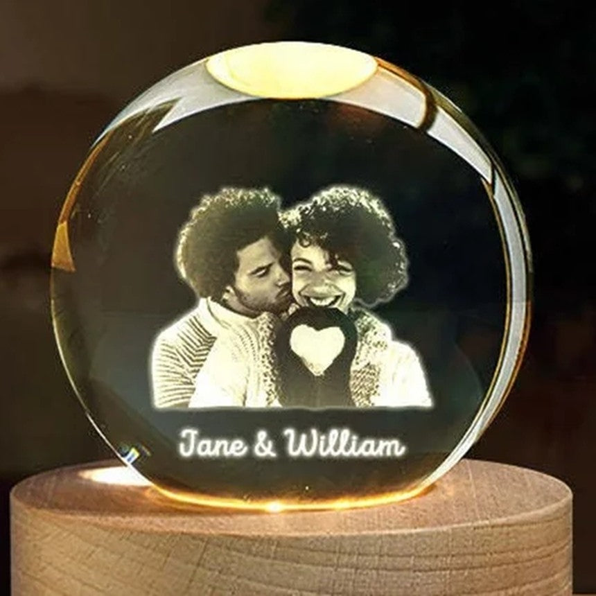Small engraved crystal globe lit up on its wooden base