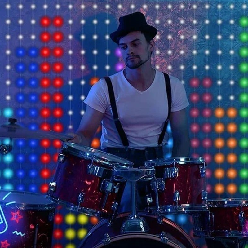 LED curtain lights pulsing to the music behind a drummer