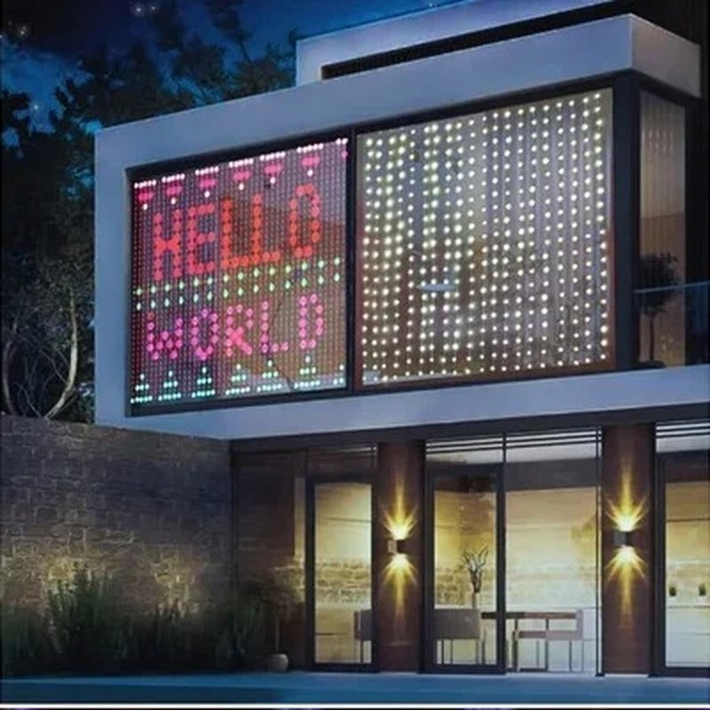 House window at night with the LED curtain showing Hello World